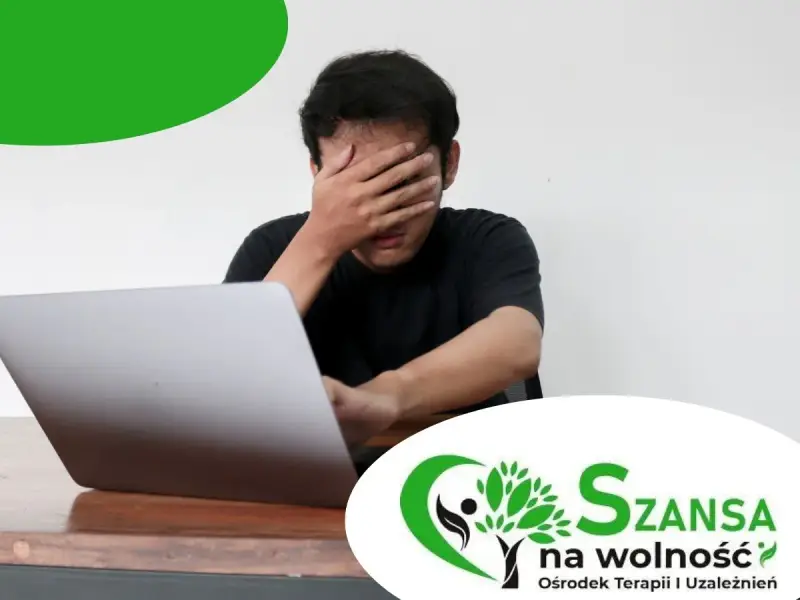 Mężczyzna z ręką na twarzy przed laptopem. Szansa na wolność - ośrodek terapii uzależnień, oferuje leczenie uzależnienia od pornografii.